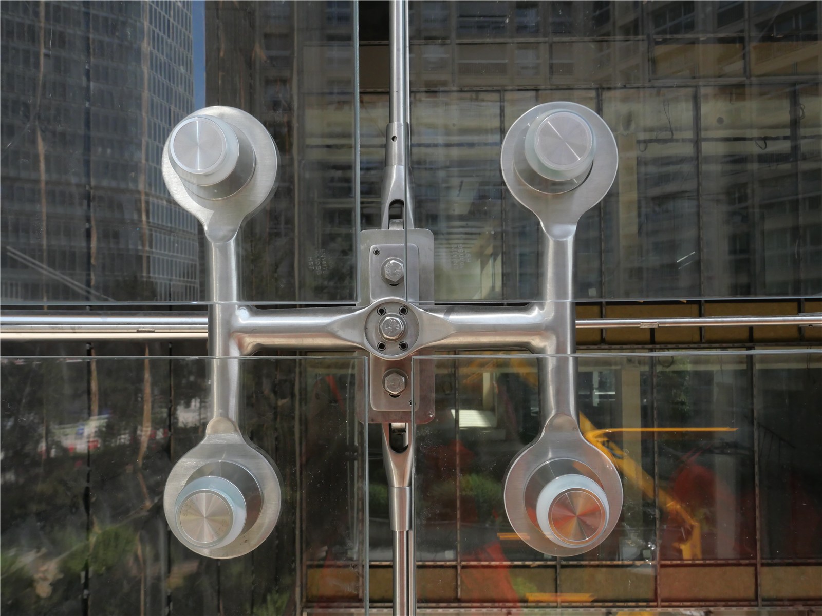 Attache de vitrage extérieur agrafé en inox sur une façade câblée